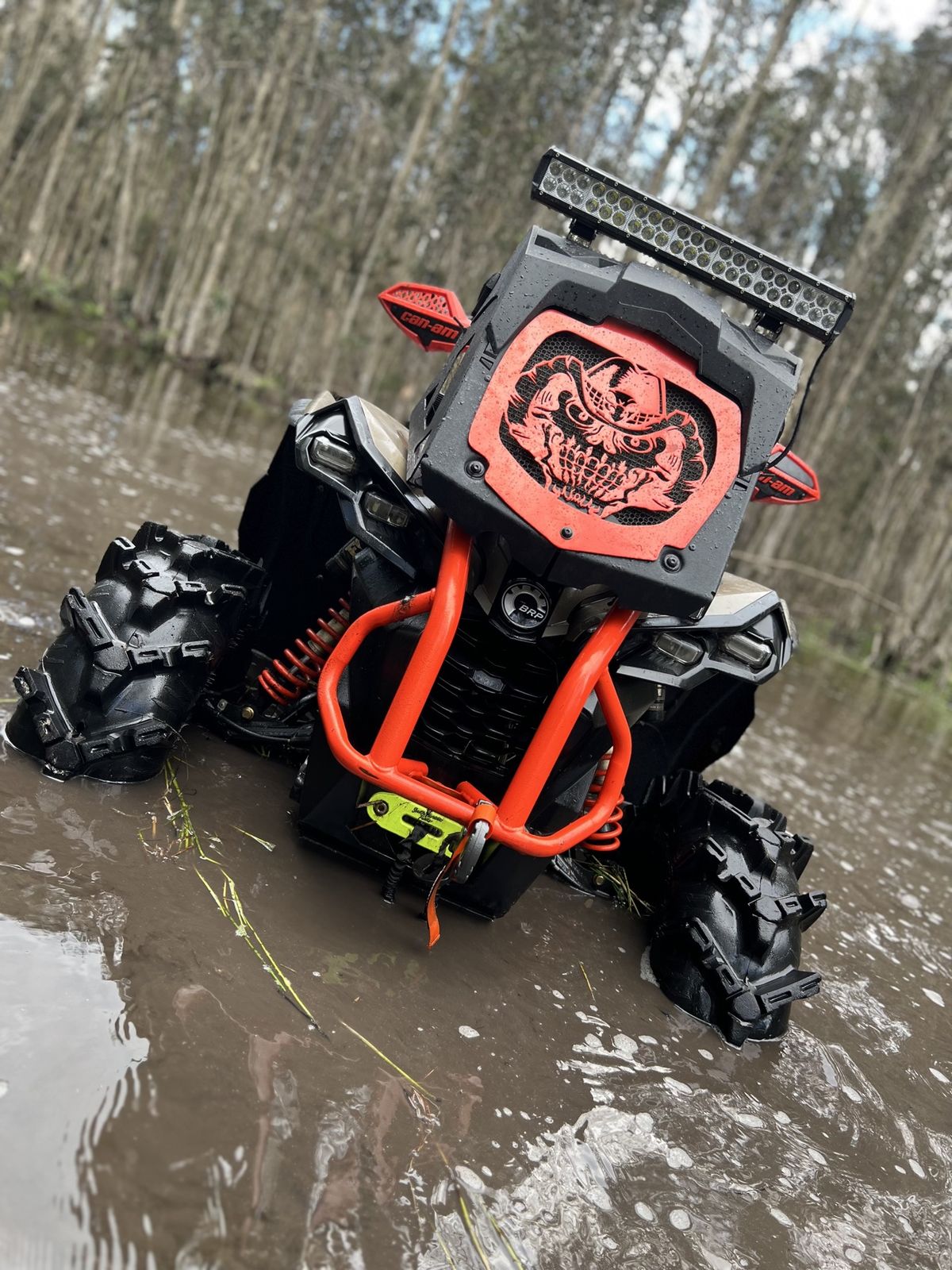 Close-up of a muddy ATV in the swamp