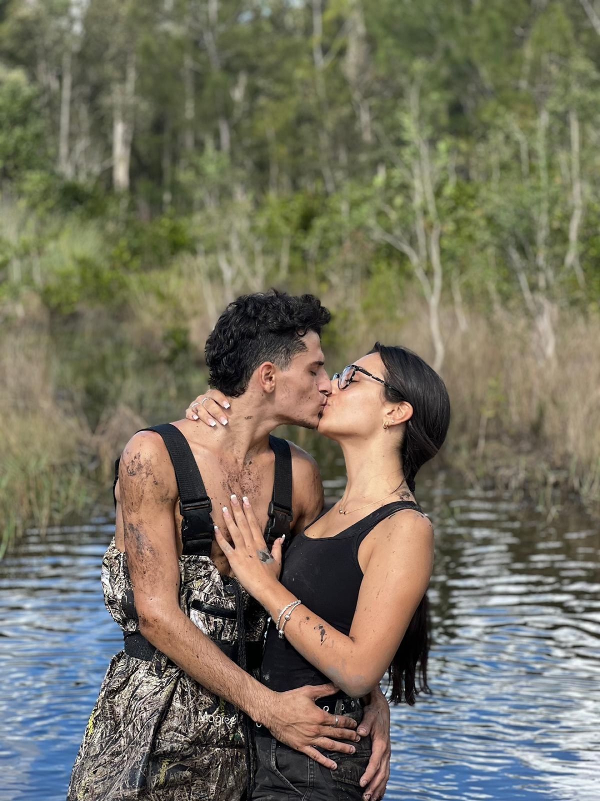 Muddy couple embracing on the trail