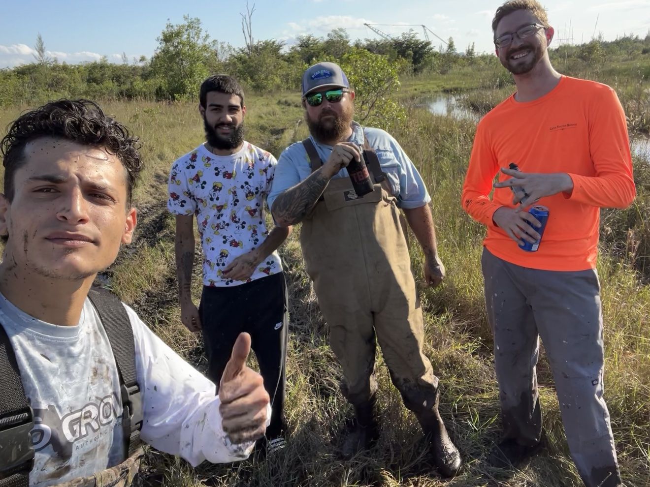 Group selfie of four riders on the trail