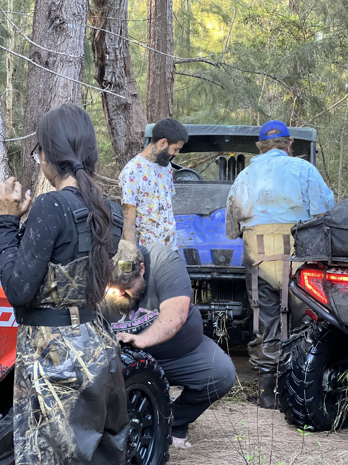 Group of riders gathered around their machines