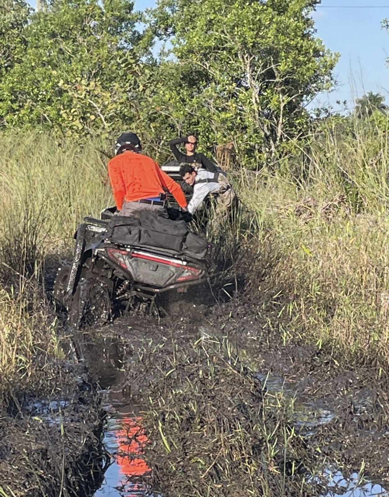 ATV deep in a muddy rut