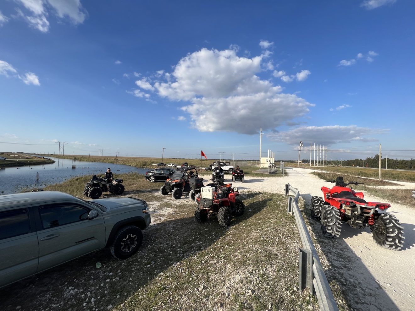 Staging area with trucks, trailers and ATVs