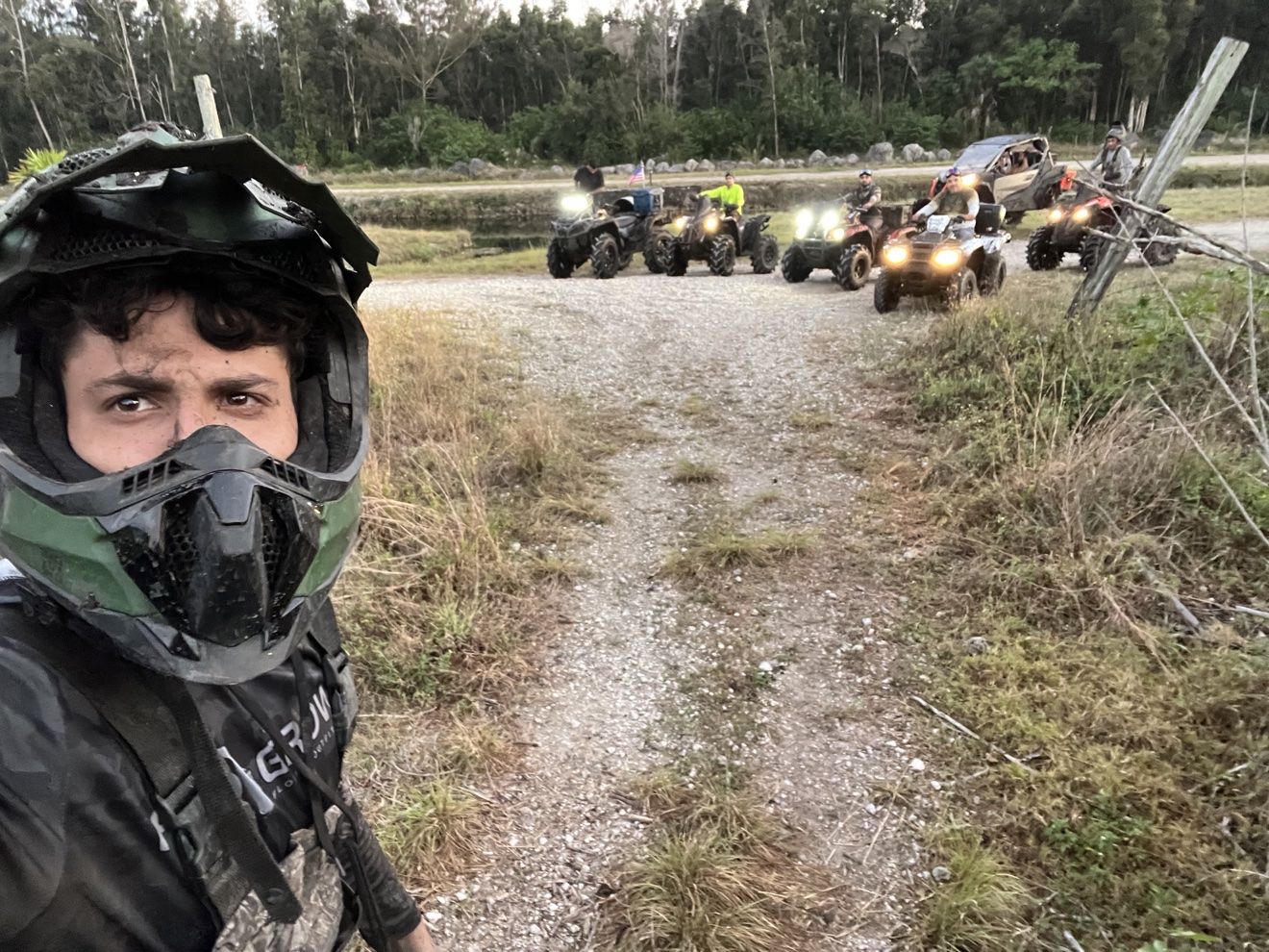 Helmet selfie with an ATV lineup behind