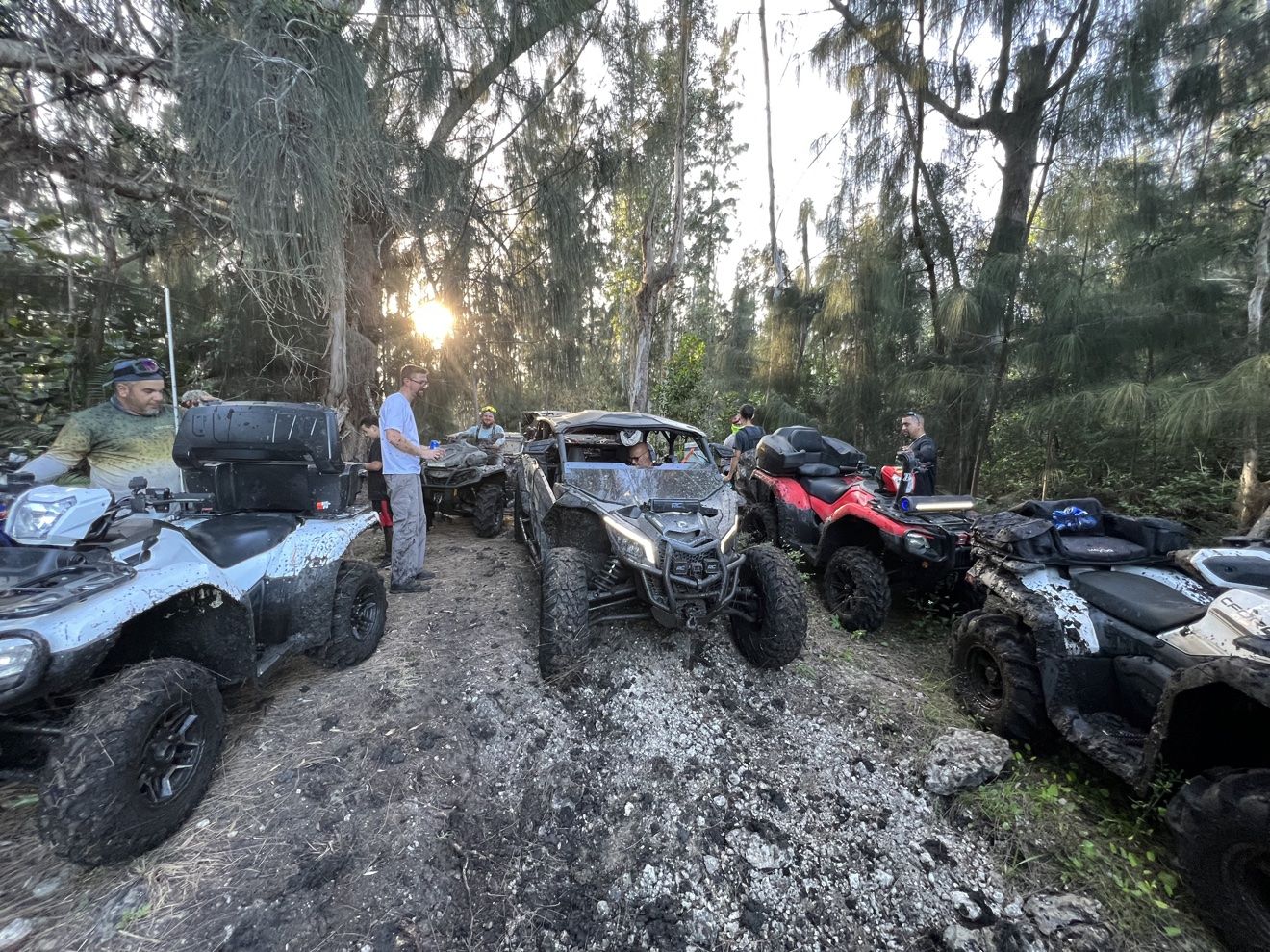ATVs at a muddy staging area at dusk