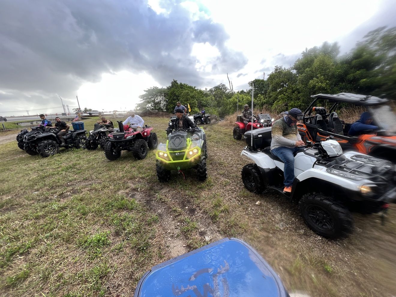 Wide lineup of ATVs and SXSs at a staging area