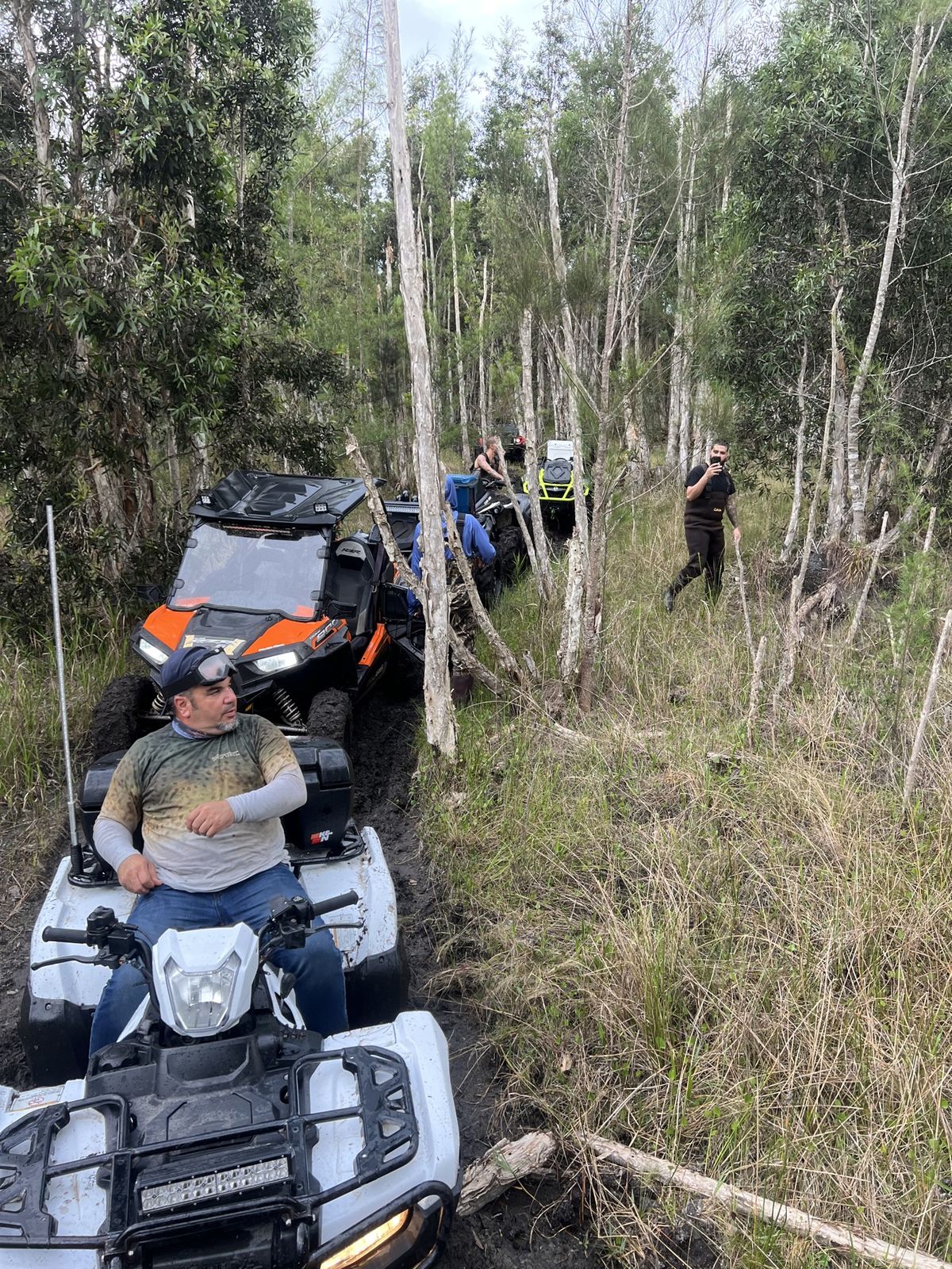 Rider pushing an ATV through deep mud