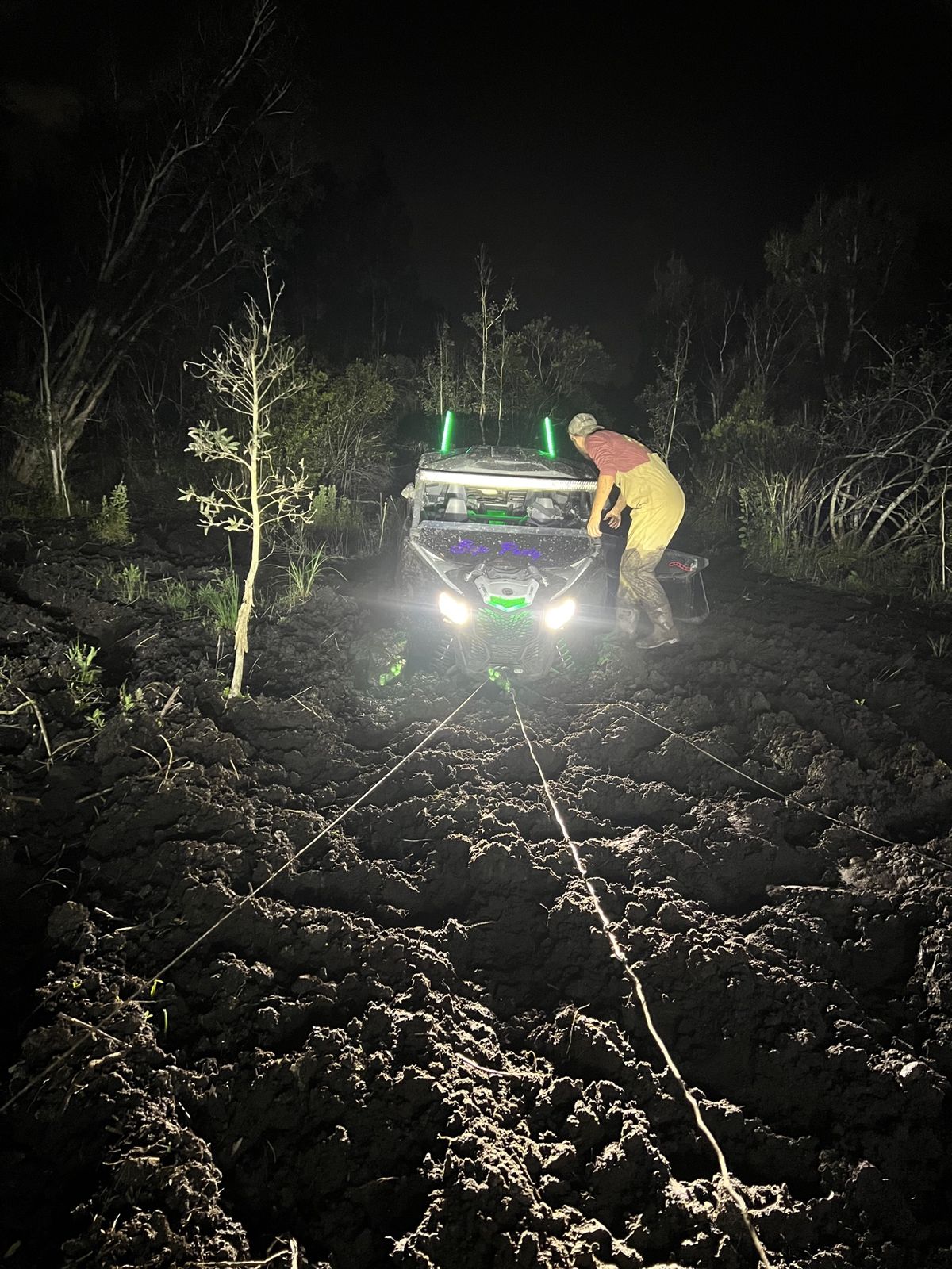 Night recovery pulling an ATV out of deep mud