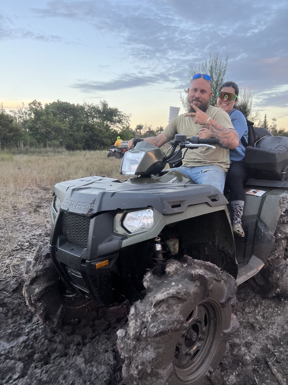 Two riders at a muddy staging area