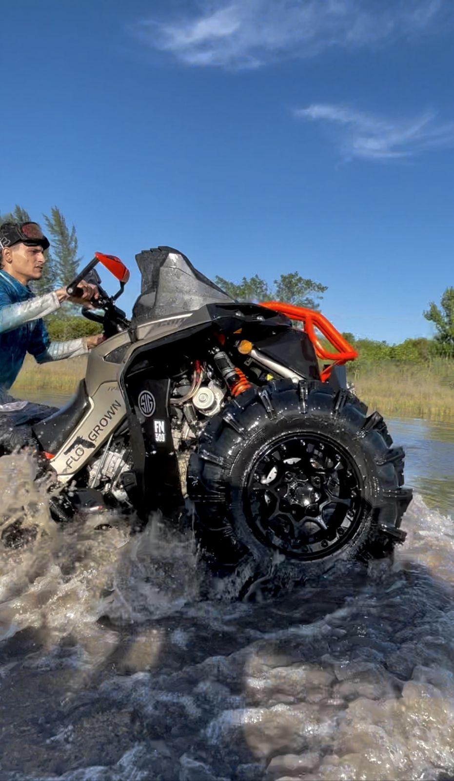 ATV splashing through a water crossing
