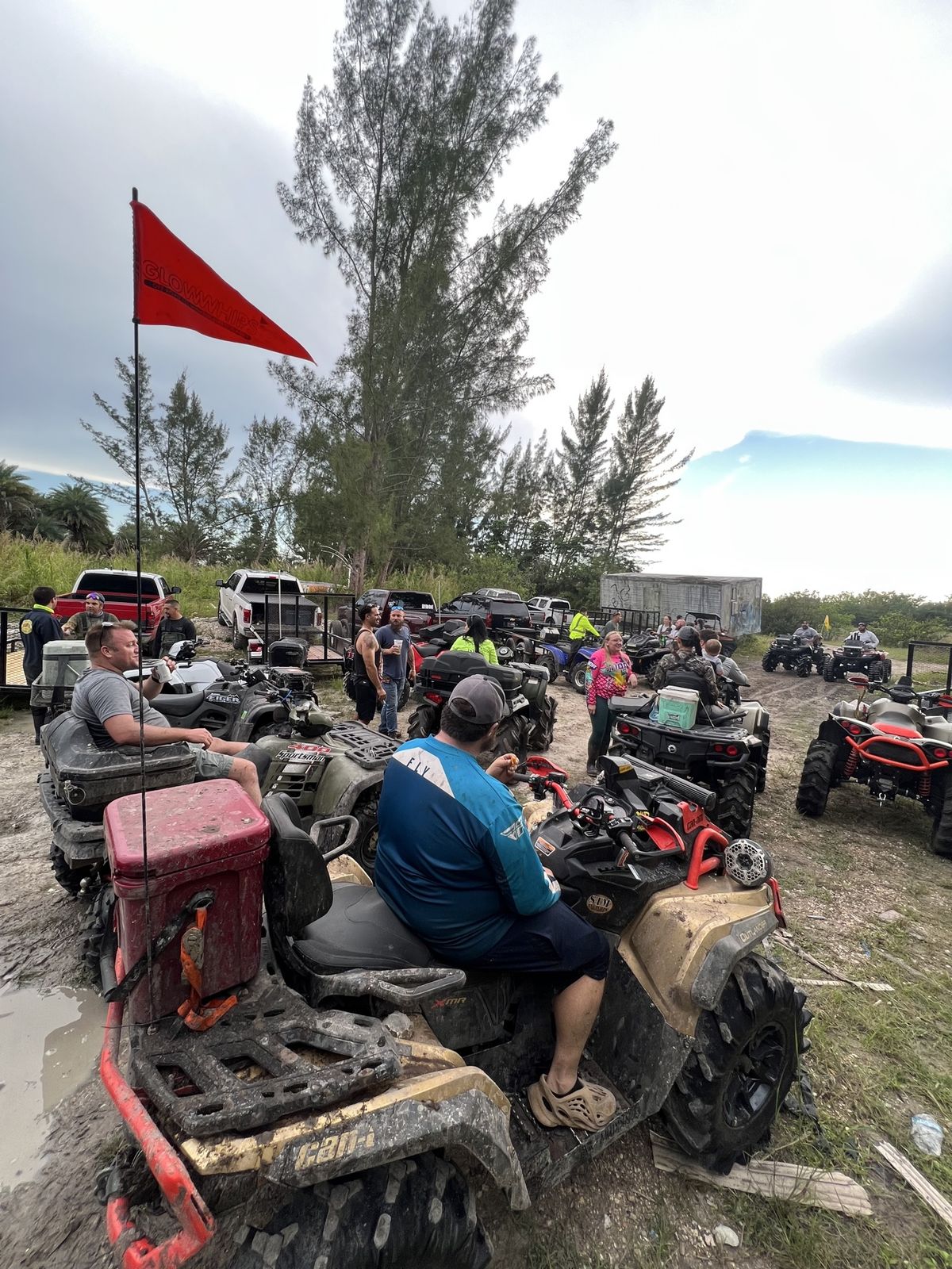 Staging area with ATVs and a red flag