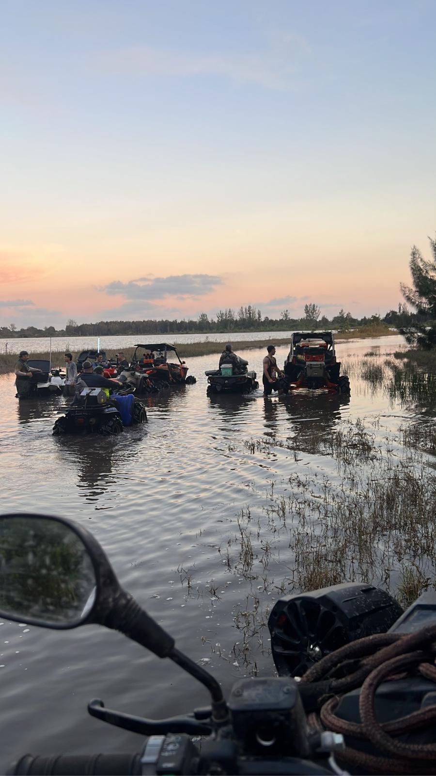 Sunset selfie over the water with ATVs behind