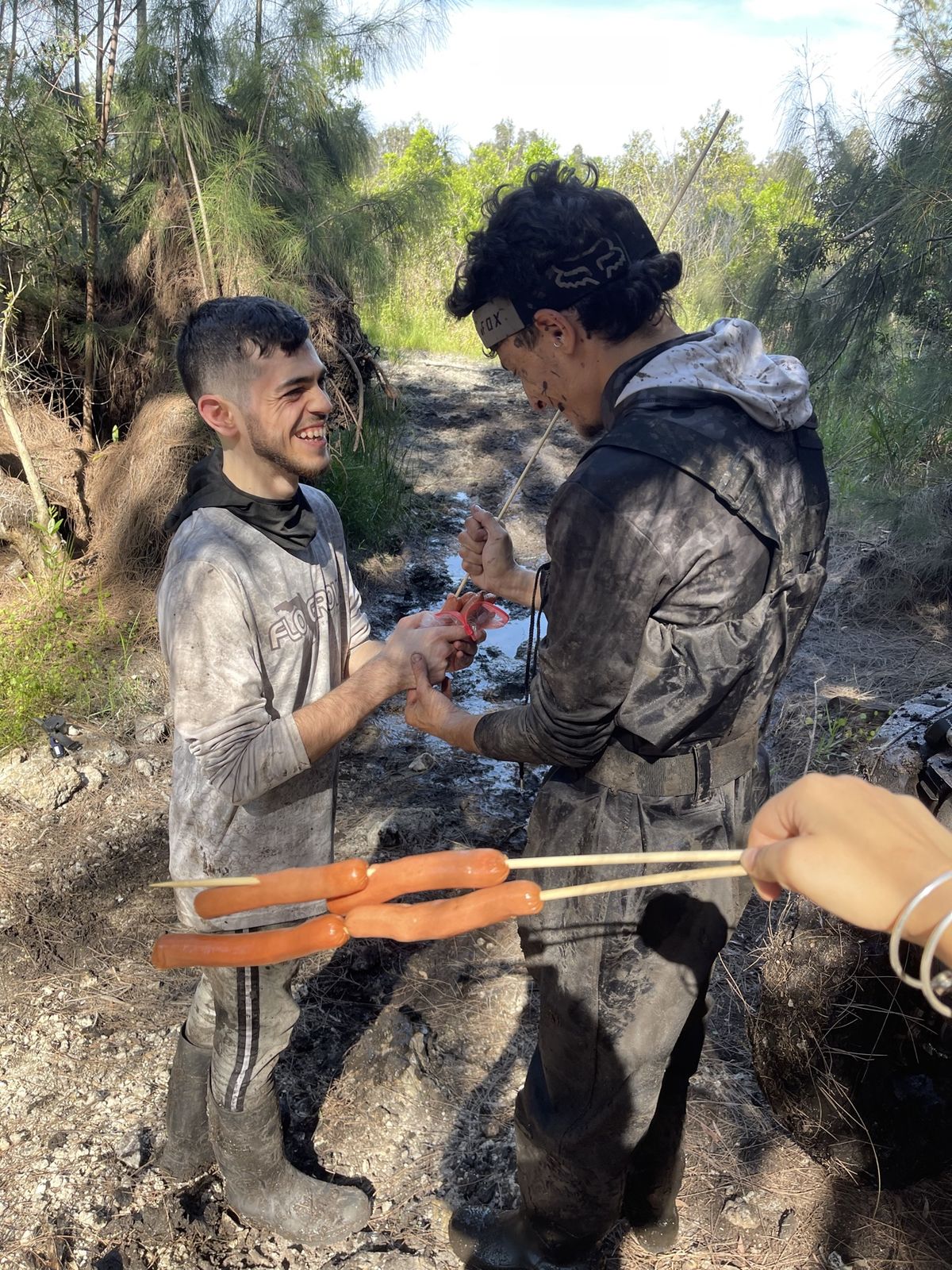 Trail cookout with hot dogs on sticks